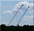 Cranes carrying lighting gantries for filming