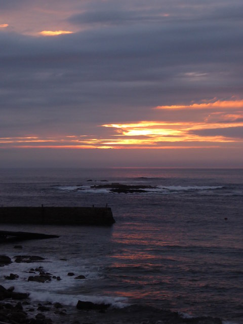 Sunset behind a threatening sky at Sennen Cove
