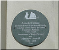 Grey plaque indicating the former home of the Arnold family