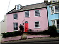 Pink house with a red door and a blue plaque, Cobb Road, Lyme Regis