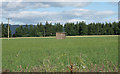 Small building in the middle of a field