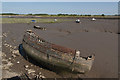 Derelict and aground at low water