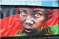 View of a Dale Grimshaw mural on the side of a chemist on Forest Road from Chingford Road