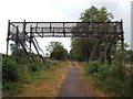 SP7576 : Derelict footbridge over Brampton Valley Way by Malc McDonald