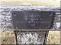 TL8628 : Plaque on the seat  in St. Andrew's Churchyard by Geographer