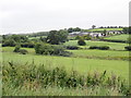 View across the Dorsy Valley towards a farm above the A29