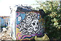 View of street art on the side of a shed in the Nomadic Community Garden