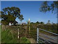 Broken footpath sign and entrance to village of Glanvilles Wootton