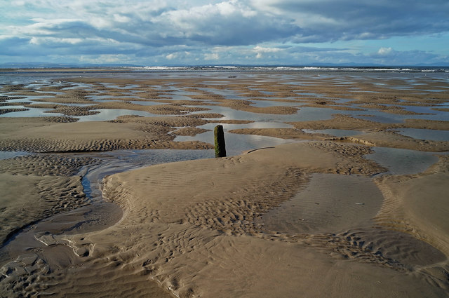 Wooden post in the sand at Findhorn