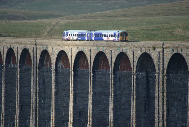 View of a Class 158 train crossing the Ribblehead Viaduct from Low Sleights Road