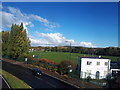 A20 and sports pavilion, seen from railway bridge