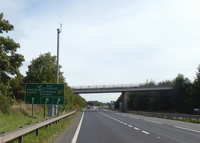 Sign, CCTV post and bridge at A14/A11 junction