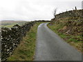 Stone wall enclosed minor road heading towards Gaeddren