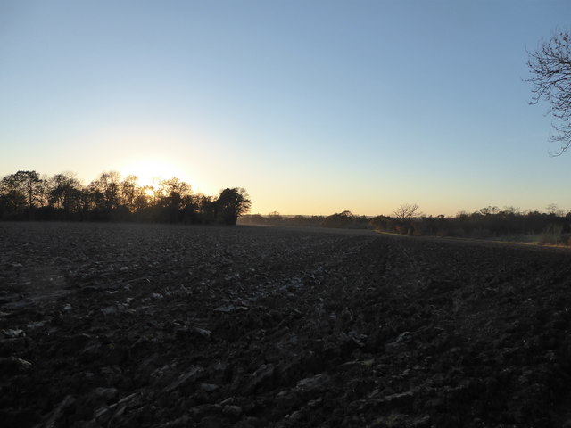 Sunset over a ploughed field