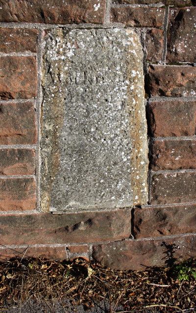 Old boundary stone embedded in the wall of Eller Bank