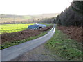 NU0809 : Minor road near to Thrunton Red House by Peter Wood