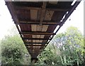 Underside of the lightweight lattice truss bridge across canal