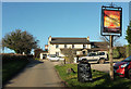 Rising Sun sign, car park and pub