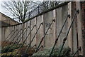 View of scaffolding poles holding up the wall by Camley Street railway bridge