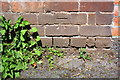 Benchmark on wall pier beside Devonshire Road railway bridge