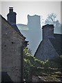 Peveril Castle seen over Castleton rooftops