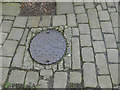 Manhole cover in a footpath