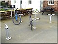 NY6137 : Pedalo cycle stands at the Village Bakery, Melmerby by Oliver Dixon