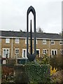 Weaving shuttle sculpture beside the canal