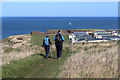 NT9364 : Walkers on the Berwickshire Coast Path by Walter Baxter