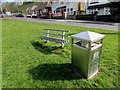 Bench and litter bin on a green in Abertridwr