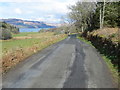 NR7574 : Road (B8024) heading towards Ballyaurgan by Peter Wood