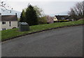 Dark green grit bin at a bend in the road, Libanus, Powys