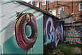 View of street art on a brick wall in a back yard off Penge High Street