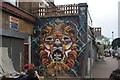 View of street art on the side wall of X-Ray Africargo on Maple Road