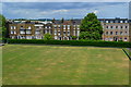 View across bowling green to New Road