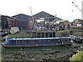 Narrow boat at untidy boat building yard, Brentford