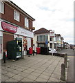 Dark green donations bin outside One Stop, Chepstow Road, Newport