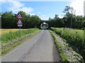 Minor road approaching bridge that used to carry railway traffic over it