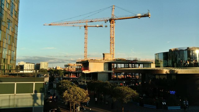 View of cranes behind North Greenwich tube station from The Tide