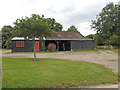 Cart shed with a John Deere three wheel tractor