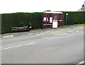 Bus stop, shelter and bench alongside a hedge, Pencader