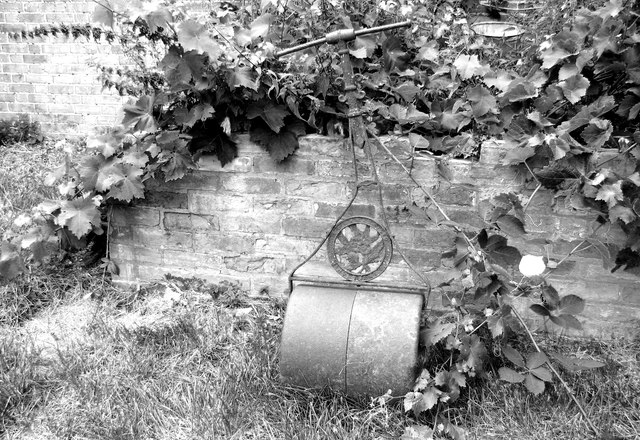 Old lawn roller in the garden of Castell farmhouse