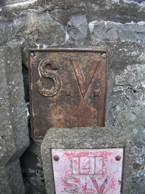 Old sluice valve marker hidden behind modern version on Ffriddoedd Road, Bangor