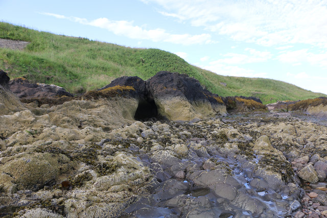 Cave cut into the foreshore rock of the River South Esk's estuary