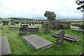 SH4560 : Graves on the south side of St Baglan's churchyard by Christine Johnstone