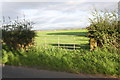 NY4257 : View through gateway towards M6 from road towards Linstock by Roger Templeman