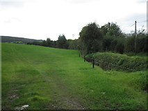 W3996 : Grass field between two roads by Jonathan Thacker
