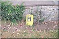 Hydrant sign by the churchyard wall