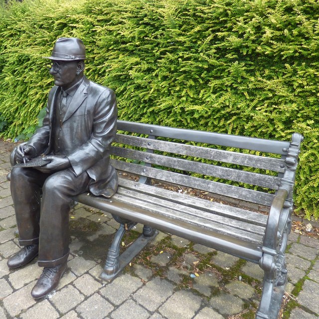 L S Lowry on a bench