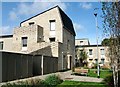 Three-storey flats book-ending two-storey houses